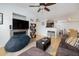 This living room has wood floors, a TV mounted over a fireplace, and opens to the kitchen with a breakfast bar at 700 Daniel Ellis Dr # 8304, Charleston, SC 29412