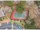 Aerial view of a tennis court adjacent to a parking lot with mature trees and landscaping surrounding the court at 700 Daniel Ellis Dr # 8304, Charleston, SC 29412