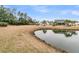 Scenic backyard view featuring pond, surrounding greenery, and glimpses of nearby houses at 714 Battery Edge Dr, Summerville, SC 29486