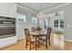 Bright dining room with wood table, chandelier, and views from the multiple windows at 714 Battery Edge Dr, Summerville, SC 29486