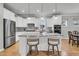 Bright kitchen with stainless steel appliances, white cabinets, and large central island with barstool seating at 714 Battery Edge Dr, Summerville, SC 29486