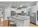 Modern kitchen with stainless steel appliances, sleek white cabinets, and central island with bar stool seating at 714 Battery Edge Dr, Summerville, SC 29486