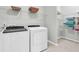 Bright laundry room with modern washer and dryer, plus wire shelving for storage at 714 Battery Edge Dr, Summerville, SC 29486