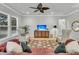 Open living room with hardwood floors, ceiling fan, and large windows for natural light at 714 Battery Edge Dr, Summerville, SC 29486