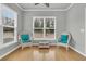 Cozy living room with lots of natural light, two wicker chairs, and hardwood floors at 714 Battery Edge Dr, Summerville, SC 29486