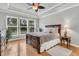 Relaxing main bedroom with a large window, tray ceiling, and decorative ceiling fan at 714 Battery Edge Dr, Summerville, SC 29486
