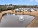 Aerial view of community pond with fountain and several homes on the edge of the pond at 714 Battery Edge Dr, Summerville, SC 29486