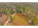 An aerial view showcasing the natural surroundings, dirt path, and house at 7537 Parkers Ferry Rd, Adams Run, SC 29426