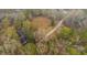 Overhead view of a quaint home surrounded by trees with long driveway at 7537 Parkers Ferry Rd, Adams Run, SC 29426