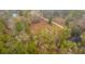 An aerial view of the property featuring lush greenery, a winding dirt path, and a charming house nestled among the trees at 7537 Parkers Ferry Rd, Adams Run, SC 29426