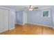 Comfortable bedroom with light-blue walls, ceiling fan, hardwood floors and natural light at 7537 Parkers Ferry Rd, Adams Run, SC 29426