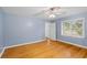 Bedroom featuring hardwood floors, a ceiling fan, and a bright window at 7537 Parkers Ferry Rd, Adams Run, SC 29426