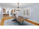 Open floor plan with a dining room featuring hardwood floors, a table, and a modern chandelier at 7537 Parkers Ferry Rd, Adams Run, SC 29426