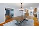 Spacious dining room featuring hardwood floors, a table, modern chandelier, and access to the kitchen at 7537 Parkers Ferry Rd, Adams Run, SC 29426