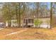 Cozy manufactured home with a front porch, brick foundation, a walkway, and a tranquil setting at 7537 Parkers Ferry Rd, Adams Run, SC 29426
