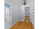 Hallway view leading to a bathroom and bedroom with hardwood flooring at 7537 Parkers Ferry Rd, Adams Run, SC 29426