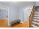 Hallway features hardwood floors, a wooden bench, and staircase at 7537 Parkers Ferry Rd, Adams Run, SC 29426