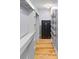 Hallway featuring wood floors, built in shelves, and a locked safe at 7537 Parkers Ferry Rd, Adams Run, SC 29426