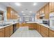 Eat-in kitchen with bright white counters and light wood cabinetry connected to living area at 7537 Parkers Ferry Rd, Adams Run, SC 29426