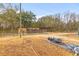Large outbuilding featuring metal siding and roof, dirt driveway, and an expansive yard at 7537 Parkers Ferry Rd, Adams Run, SC 29426