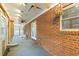 Enclosed back patio with brick, lots of windows, ceiling fans, and access to the backyard at 7537 Parkers Ferry Rd, Adams Run, SC 29426