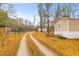 Quaint property featuring a long driveway and a manufactured home surrounded by lush trees at 7537 Parkers Ferry Rd, Adams Run, SC 29426