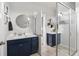 A bright ensuite bathroom features matching vanities, mirrors, and a glass shower at 775 Forrest Dr, Charleston, SC 29492