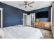 A stylish main bedroom boasts a modern ceiling fan, television, and ensuite bathroom at 775 Forrest Dr, Charleston, SC 29492