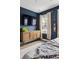 A stylish main bedroom is decorated with modern furniture, appealing curtains, and a mounted television at 775 Forrest Dr, Charleston, SC 29492