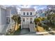 Attractive two-story home featuring a charming covered porch and a beautifully landscaped yard with palm trees at 775 Forrest Dr, Charleston, SC 29492