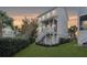 Charming home at sunset features a screened porch and staircase to the lush yard at 775 Forrest Dr, Charleston, SC 29492