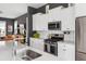 Modern kitchen features white cabinets, stainless steel appliances, and a stylish subway tile backsplash at 775 Forrest Dr, Charleston, SC 29492