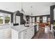 Modern, open-concept kitchen with white cabinets, stainless steel appliances and an island with seating at 775 Forrest Dr, Charleston, SC 29492