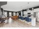 Open concept living area with kitchen, stainless steel appliances, dining and living room with a leather sofa at 775 Forrest Dr, Charleston, SC 29492