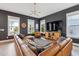 Cozy living room featuring a plush sectional sofa, accent chair, hardwood floors, and a stylish light fixture at 775 Forrest Dr, Charleston, SC 29492