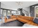 Bright and airy living room features a large leather sectional sofa, a modern light fixture, and staircase access at 775 Forrest Dr, Charleston, SC 29492