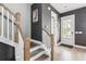 Staircase with wood treads, white risers, and a stylish modern nautical-themed wall art at 775 Forrest Dr, Charleston, SC 29492