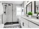 Modern bathroom with black fixtures, sleek shower, double vanity, and decorative tile flooring at 783 Lake Frances Dr, Charleston, SC 29412