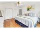 Bright bedroom with hardwood floors, white walls, closet, and a decorative yellow flower painting at 783 Lake Frances Dr, Charleston, SC 29412