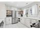 Well-lit kitchen features stainless steel appliances, white subway tile backsplash, and open shelving at 783 Lake Frances Dr, Charleston, SC 29412