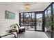 Enclosed sunroom with tiled floors and stunning views of the water and private dock at 783 Lake Frances Dr, Charleston, SC 29412