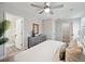 Spacious bedroom has a ceiling fan and opens up to a view of the ensuite bathroom and walk-in closet at 826 Alma Square Dr, Moncks Corner, SC 29461