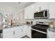 Bright, modern kitchen features granite countertops and stainless steel appliances at 826 Alma Square Dr, Moncks Corner, SC 29461