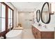 Luxurious bathroom with a soaking tub, dual vanity sinks, and walk-in shower at 916 Kincade Dr, Mount Pleasant, SC 29464