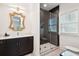 Chic bathroom featuring a modern vanity, decorative mirror, and a tiled walk-in shower at 916 Kincade Dr, Mount Pleasant, SC 29464