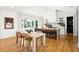Open dining room with hardwood floors, dining table and adjacent kitchen island with barstools at 916 Kincade Dr, Mount Pleasant, SC 29464
