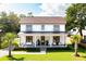 Charming two-story home boasting a welcoming front porch with comfortable seating and beautifully landscaped yard at 916 Kincade Dr, Mount Pleasant, SC 29464