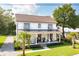 Charming two-story home with a welcoming front porch, lush lawn, and palm trees at 916 Kincade Dr, Mount Pleasant, SC 29464