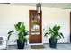 Elegant front door adorned with a wreath, complemented by potted plants and stylish outdoor lighting at 916 Kincade Dr, Mount Pleasant, SC 29464