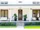 Charming front porch with comfortable seating, a decorative wreath, and lush landscaping at 916 Kincade Dr, Mount Pleasant, SC 29464